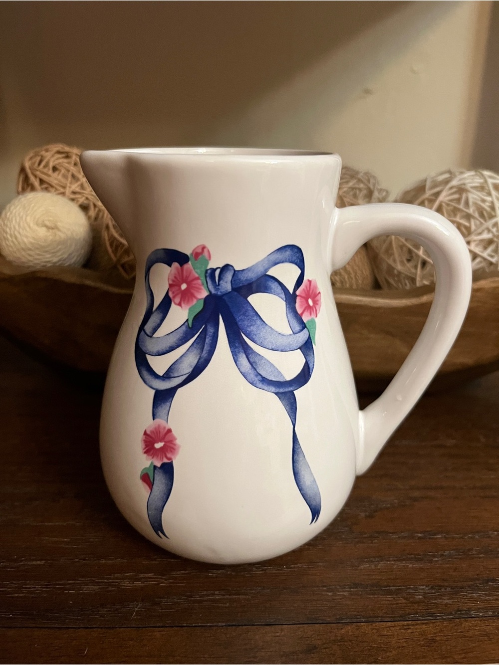 White Ceramic Pitcher with Blue Ribbon and Pink Floral Design